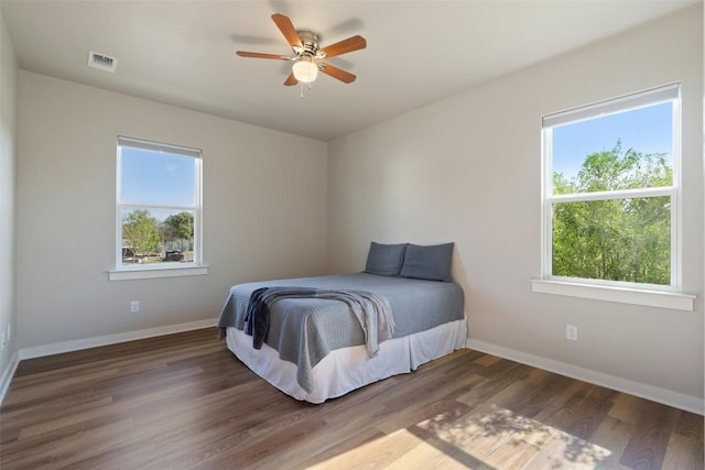 200 County Road 246, Florence, TX 76527 - bedroom featuring multiple windows, baseboards, and wood finished floors