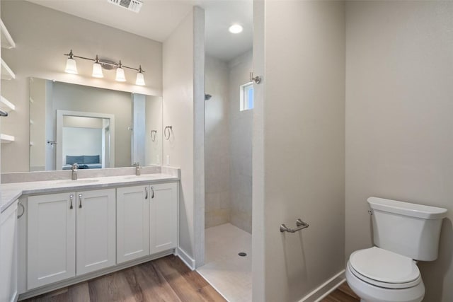 200 County Road 246, Florence, TX 76527 - bathroom featuring double vanity, walk in shower, and wood finished floors
