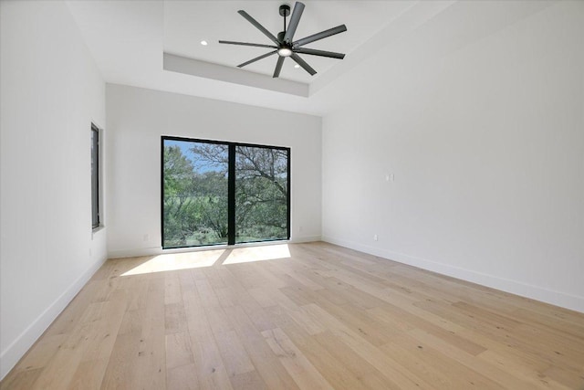 317 Azalea Ct, Horseshoe Bay, TX 78657 - empty room featuring a raised ceiling, light wood-style floors, baseboards, ceiling fan, and recessed lighting