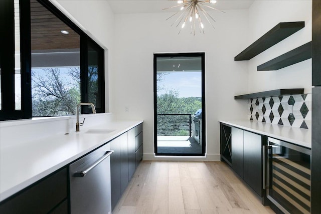317 Azalea Ct, Horseshoe Bay, TX 78657 - indoor dry bar with stainless steel dishwasher, beverage cooler, a chandelier, light wood-style floors, and baseboards