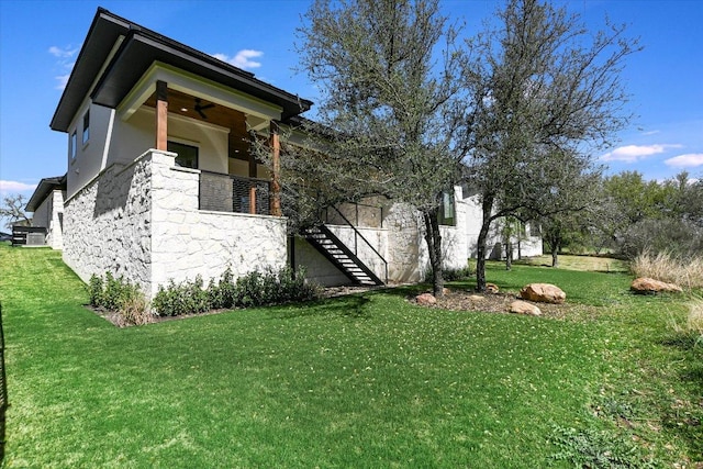 317 Azalea Ct, Horseshoe Bay, TX 78657 - view of front facade featuring stairs, stone siding, and a front lawn