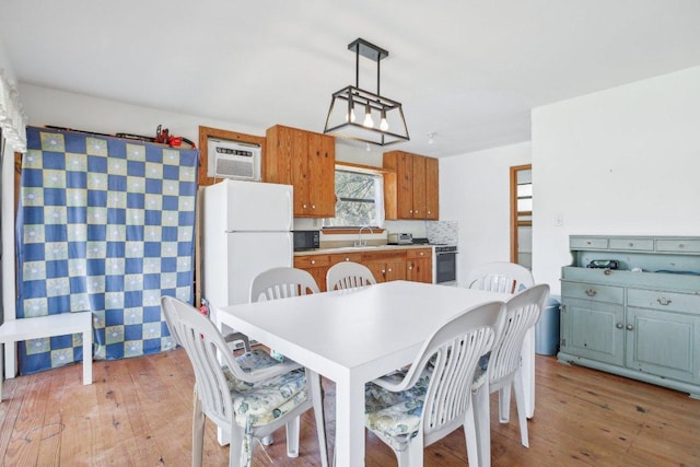 520 River Rapids Rd, Wimberley, TX 78676 - dining room featuring light wood finished floors and an AC wall unit