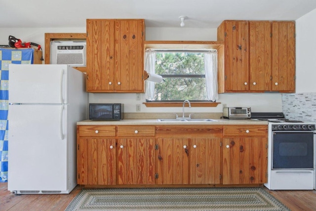 520 River Rapids Rd, Wimberley, TX 78676 - kitchen featuring white appliances, wood finished floors, light countertops, and brown cabinets
