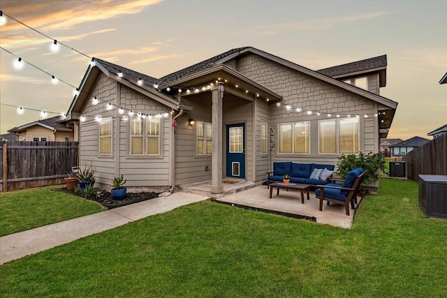 235 Witchhazel Way, San Marcos, TX 78666 - back of property at dusk featuring an outdoor living space and a patio area