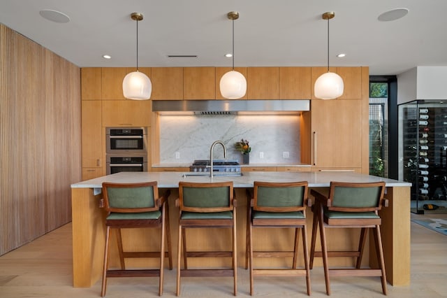 kitchen featuring double oven, backsplash, modern cabinets, and light countertops
