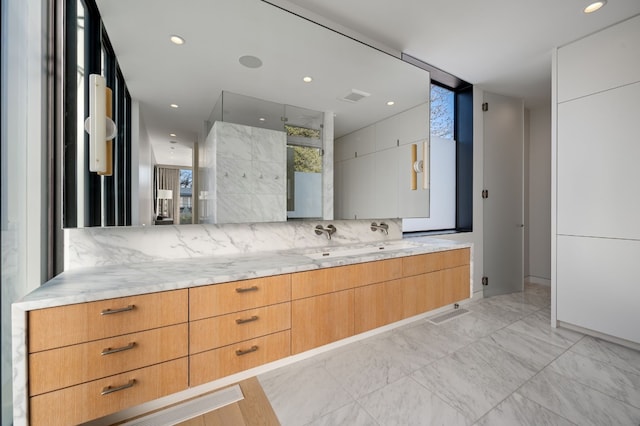 701 W Elizabeth St, Austin, TX 78704 - bathroom featuring vanity, marble look tiles, tasteful backsplash, a shower, and recessed lighting