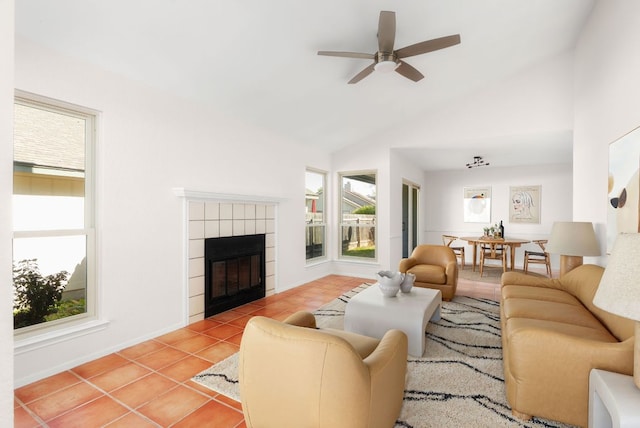 living area featuring a tiled fireplace, light tile patterned flooring, and plenty of natural light