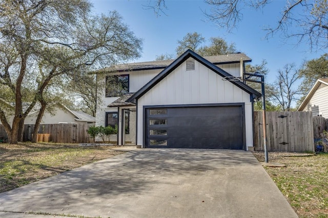 4209 Everest Ln, Austin, TX 78727 - modern farmhouse style home with a garage, driveway, roof with shingles, and board and batten siding