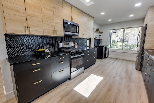 4209 Everest Ln, Austin, TX 78727 - kitchen with appliances with stainless steel finishes, dark countertops, light wood-style flooring, tasteful backsplash, and recessed lighting