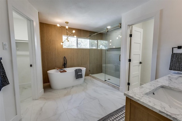 4209 Everest Ln, Austin, TX 78727 - full bath featuring a stall shower, a freestanding bath, double vanity, marble finish flooring, and a walk in closet
