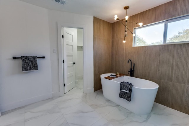 4209 Everest Ln, Austin, TX 78727 - full bath featuring a freestanding tub, marble finish floors, and a chandelier
