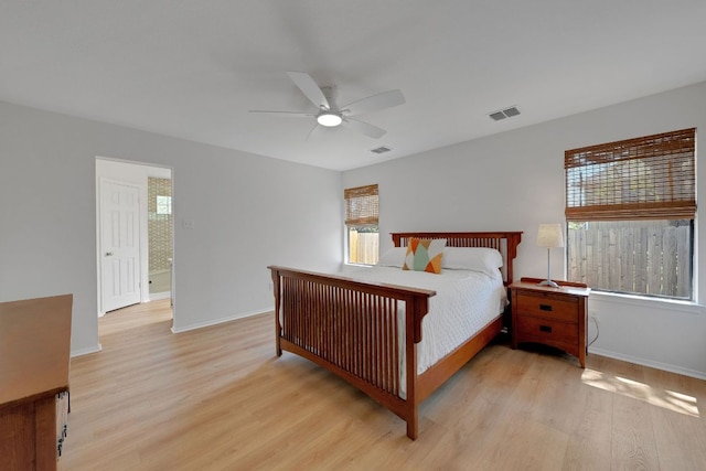 bedroom with light wood finished floors, baseboards, visible vents, and ceiling fan