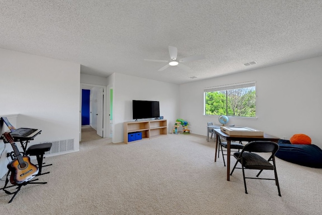 living room with carpet flooring, a textured ceiling, visible vents, and a ceiling fan