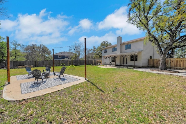 view of yard featuring an outdoor fire pit, a fenced backyard, and a patio area