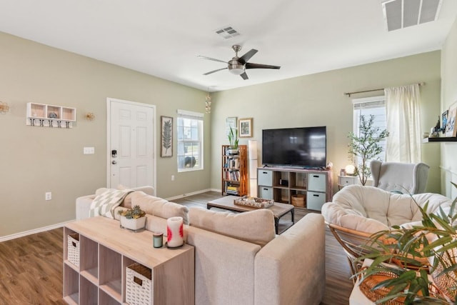 14128 Sandrock Bnd, Pflugerville, TX 78660 - living room with ceiling fan, dark wood finished floors, and baseboards