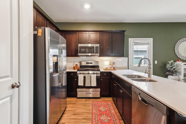 14128 Sandrock Bnd, Pflugerville, TX 78660 - kitchen featuring stainless steel appliances, a sink, light countertops, backsplash, and recessed lighting