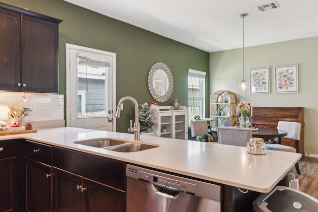 14128 Sandrock Bnd, Pflugerville, TX 78660 - kitchen with stainless steel dishwasher, a sink, light countertops, decorative backsplash, and pendant lighting
