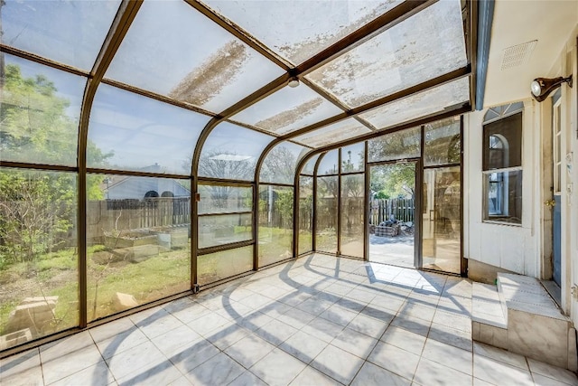 unfurnished sunroom with visible vents and a healthy amount of sunlight