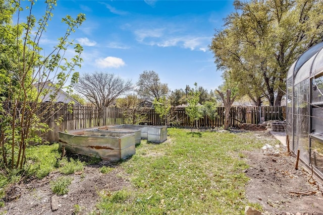 view of yard with a fenced backyard and a vegetable garden