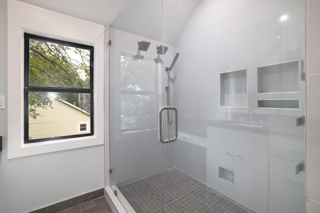 933 E 52nd St, Austin, TX 78751 - bathroom featuring a stall shower, vaulted ceiling, and tile patterned flooring