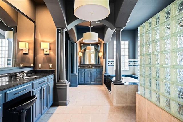11801 Astoria Dr, Bee Cave, TX 78738 - full bathroom with decorative columns, a garden tub, and vanity