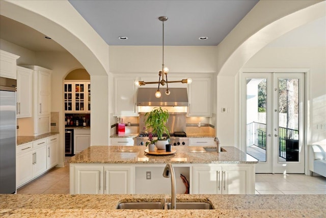 11801 Astoria Dr, Bee Cave, TX 78738 - kitchen with a sink, built in fridge, light tile patterned floors, and under cabinet range hood