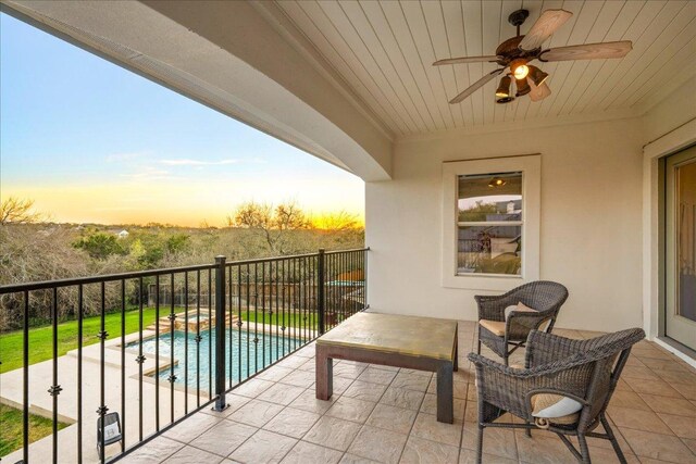 11801 Astoria Dr, Bee Cave, TX 78738 - balcony at dusk featuring a patio area, a ceiling fan, view of pool area, and a pool with connected hot tub