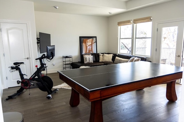 rec room featuring baseboards and dark wood-type flooring