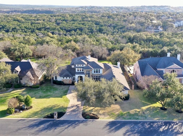drone / aerial view featuring a wooded view