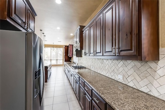 3519 Alexandrite Way, Round Rock, TX 78681 - kitchen featuring appliances with stainless steel finishes, backsplash, dark brown cabinets, recessed lighting, and stone countertops