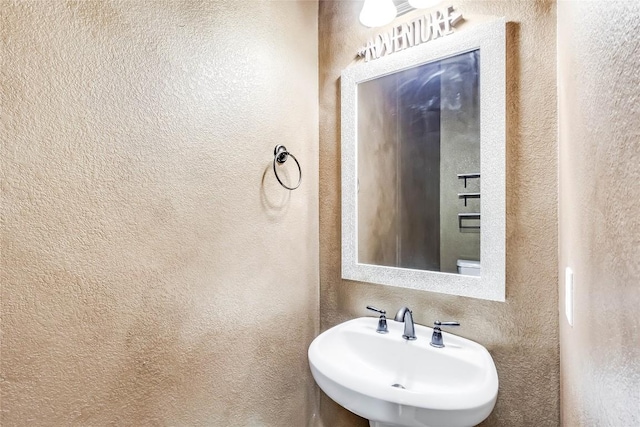 3519 Alexandrite Way, Round Rock, TX 78681 - bathroom with a textured wall and a sink