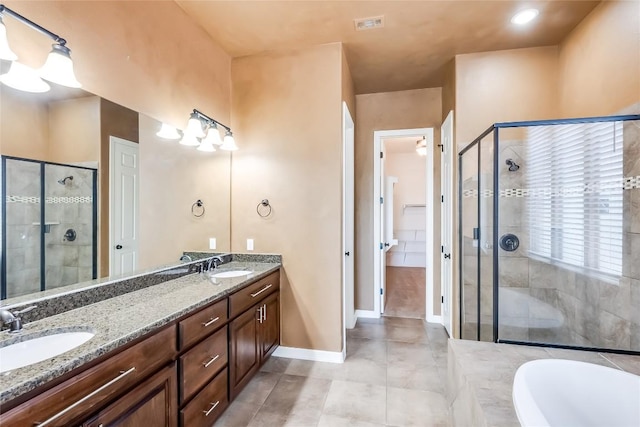 3519 Alexandrite Way, Round Rock, TX 78681 - full bath with a stall shower, double vanity, a garden tub, and tile patterned flooring