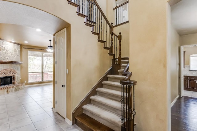 3519 Alexandrite Way, Round Rock, TX 78681 - stairs with a fireplace, arched walkways, and tile patterned floors