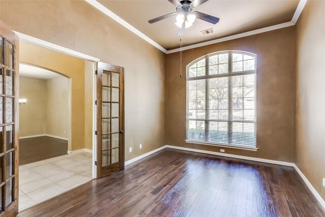 3519 Alexandrite Way, Round Rock, TX 78681 - spare room featuring wood finished floors, ornamental molding, arched walkways, french doors, and a ceiling fan