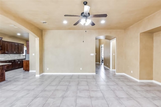 3519 Alexandrite Way, Round Rock, TX 78681 - unfurnished living room with arched walkways, ceiling fan, light tile patterned floors, and recessed lighting
