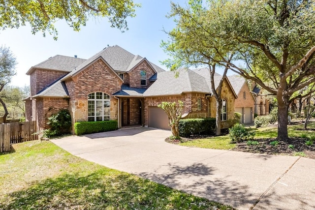 3519 Alexandrite Way, Round Rock, TX 78681 - view of front of home with an attached garage, brick siding, concrete driveway, a shingled roof, and stone siding