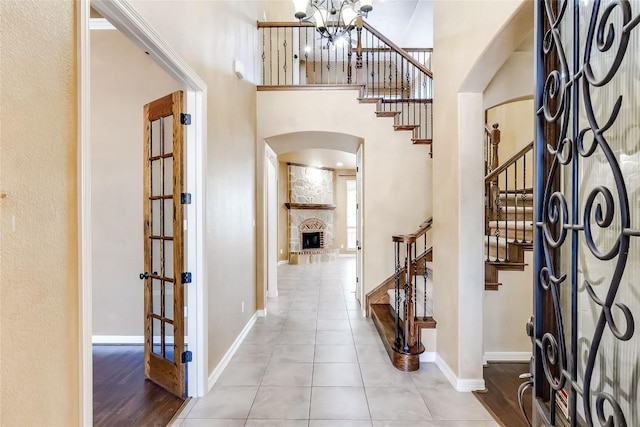 3519 Alexandrite Way, Round Rock, TX 78681 - entryway with arched walkways, stairs, a high ceiling, tile patterned floors, and a chandelier