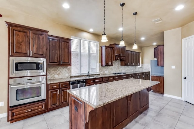 3519 Alexandrite Way, Round Rock, TX 78681 - kitchen with appliances with stainless steel finishes, backsplash, light tile patterned floors, light stone counters, and recessed lighting