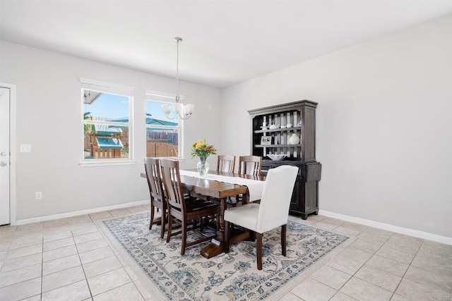 366 Eagle Brook Ln, Buda, TX 78610 - dining space with light tile patterned floors, a chandelier, and baseboards