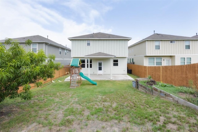 366 Eagle Brook Ln, Buda, TX 78610 - back of property featuring a fenced backyard, a playground, and board and batten siding
