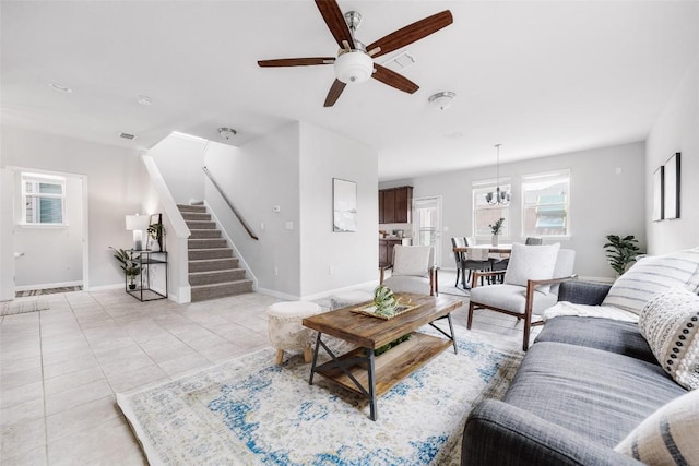 366 Eagle Brook Ln, Buda, TX 78610 - living area with a ceiling fan, stairway, healthy amount of natural light, and light tile patterned floors