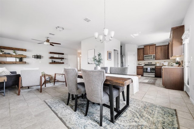366 Eagle Brook Ln, Buda, TX 78610 - dining area featuring light tile patterned floors, a chandelier, and ceiling fan