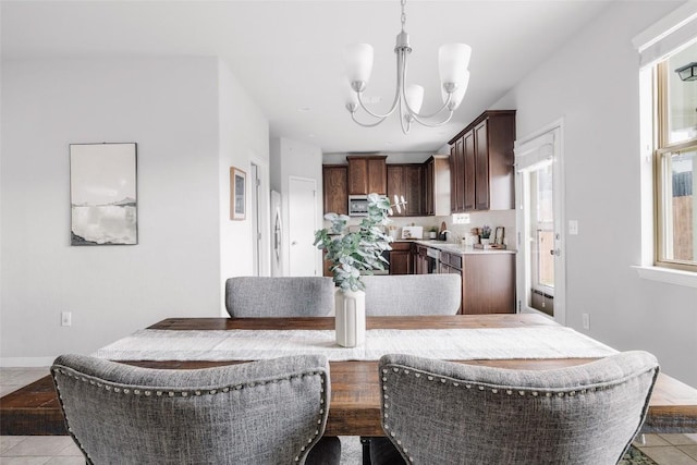 366 Eagle Brook Ln, Buda, TX 78610 - dining area featuring a chandelier and light tile patterned flooring