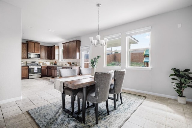 366 Eagle Brook Ln, Buda, TX 78610 - dining room featuring a chandelier and light tile patterned floors