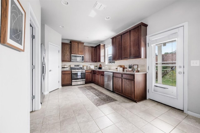 366 Eagle Brook Ln, Buda, TX 78610 - kitchen with appliances with stainless steel finishes, healthy amount of natural light, backsplash, light countertops, and recessed lighting