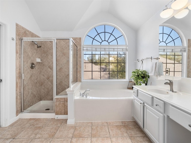 full bath featuring a shower stall, lofted ceiling, vanity, and a garden tub