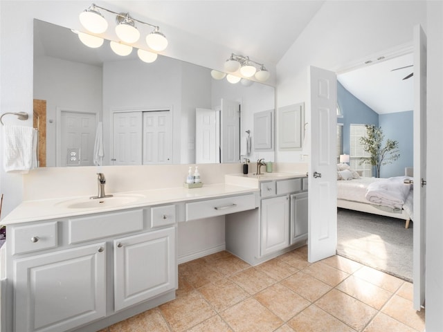 11009 Savannah Ct, Austin, TX 78739 - bathroom featuring vaulted ceiling, double vanity, tile patterned flooring, and ensuite bathroom