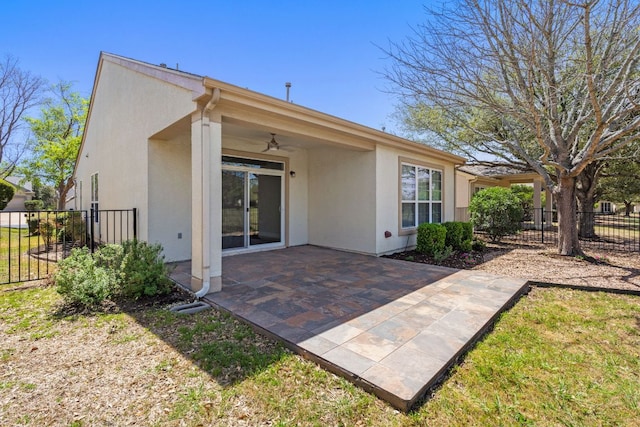 210 Crockett Loop, Georgetown, TX 78633 - back of property with ceiling fan, stucco siding, fence, and a patio