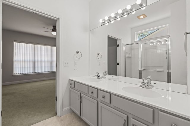210 Crockett Loop, Georgetown, TX 78633 - bathroom with a ceiling fan, an enclosed shower, double vanity, and baseboards