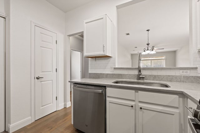210 Crockett Loop, Georgetown, TX 78633 - kitchen featuring dishwasher, a sink, decorative backsplash, and white cabinets